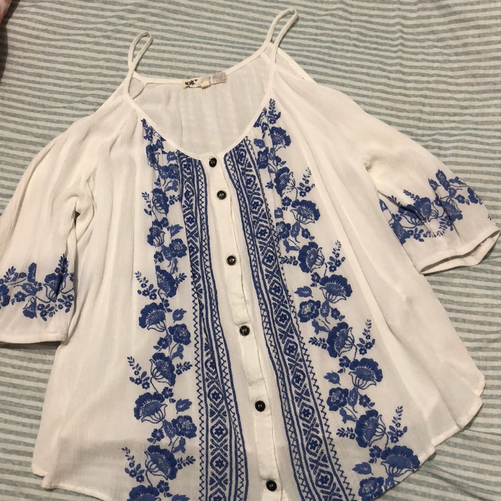 White blouse with blue embroidery